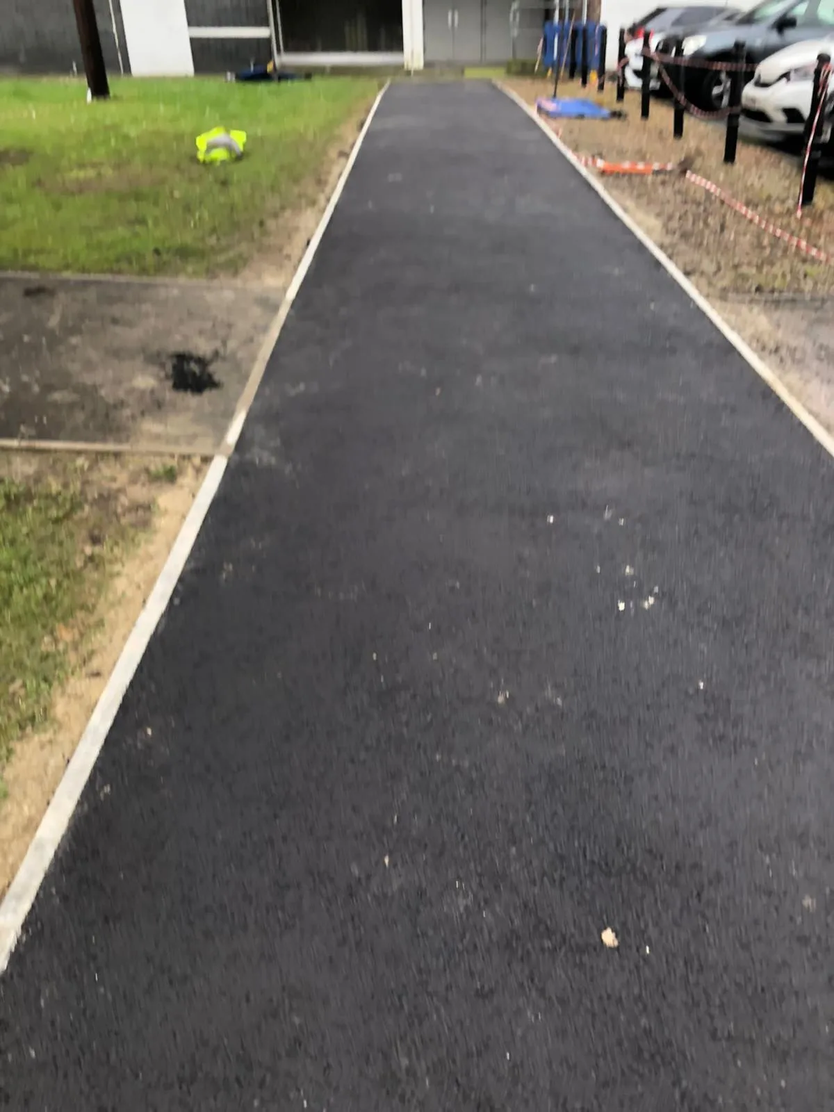A new tarmac footpath with a fresh kerb edging