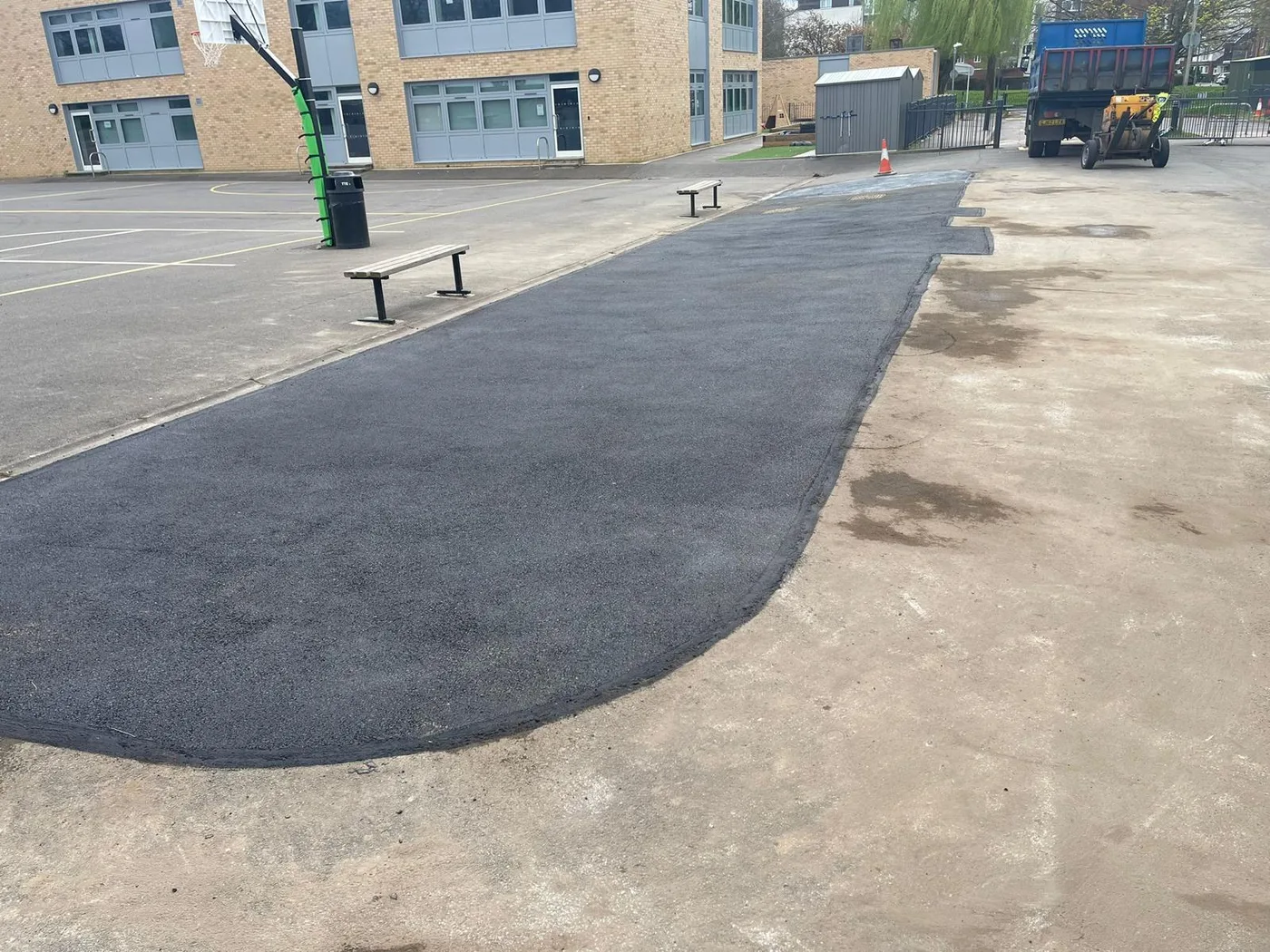 A resurfaced school hard play area with a curved edge
