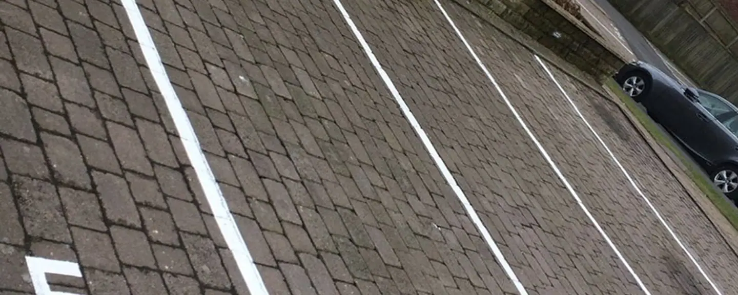 White bay markings set out on new tarmac — Car Park Resurfacing in Lambeth by Meads Resurfacing
