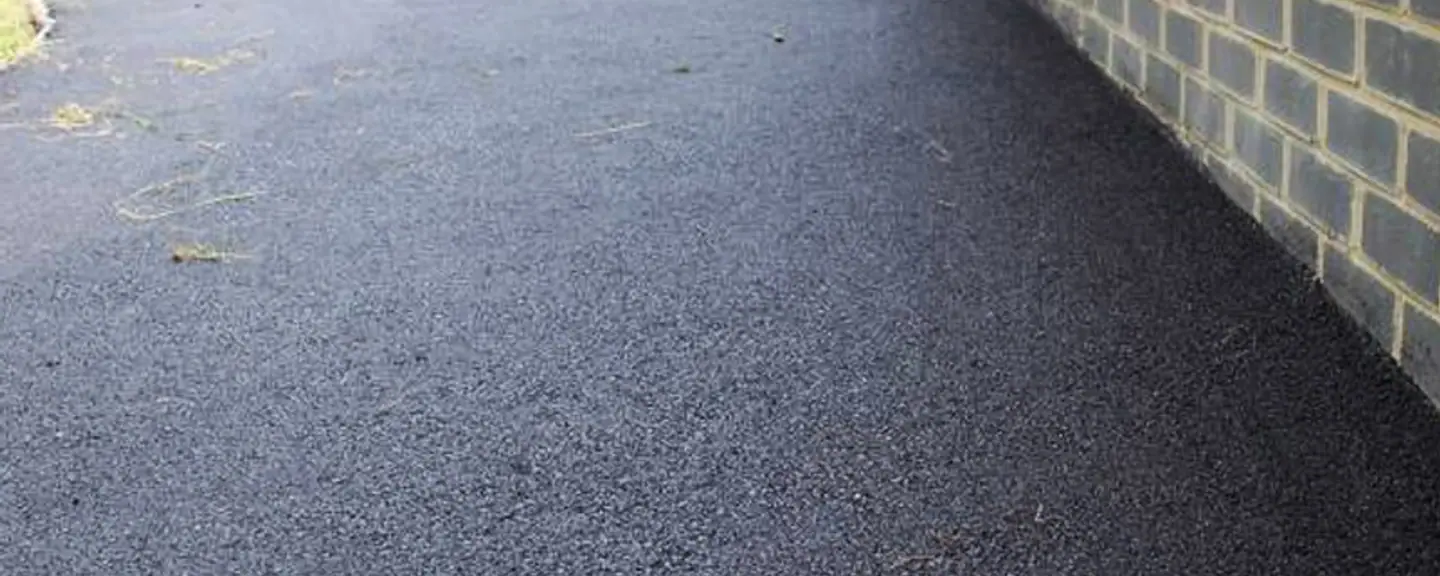 A tarmac path curving through a landscaped area — Path Resurfacing in Piccadilly by Meads Resurfacing