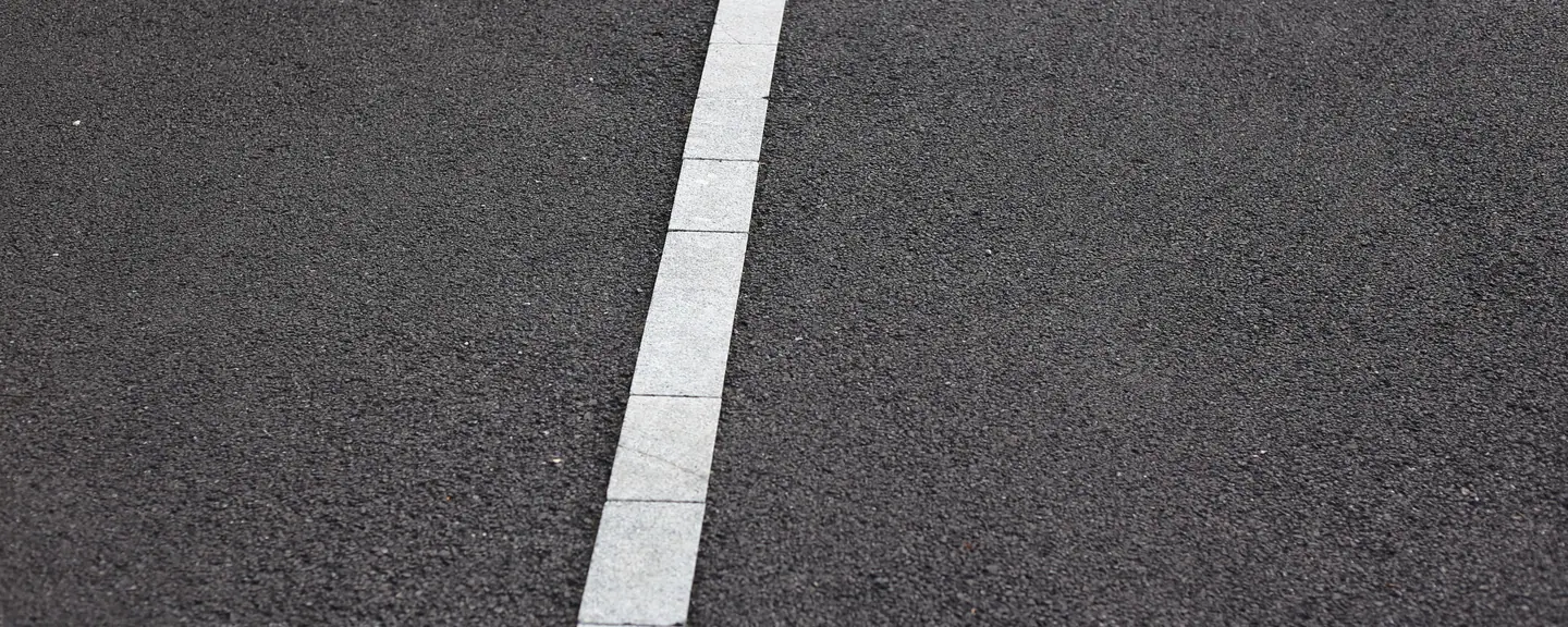 A white line marked along a tarmac path — Path Resurfacing in Barnet by Meads Resurfacing