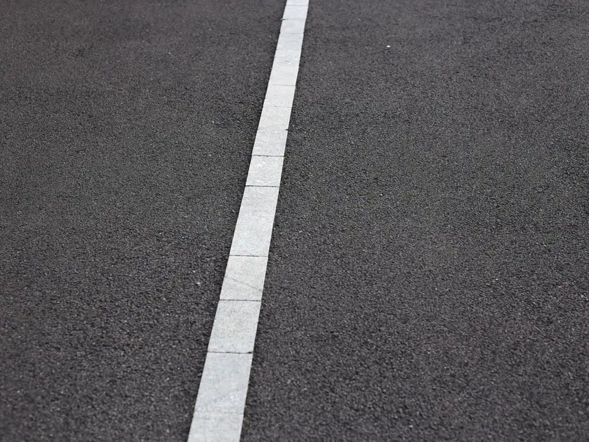 A white line marked along a tarmac path