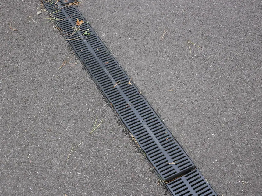 A channel drain along a resurfaced path