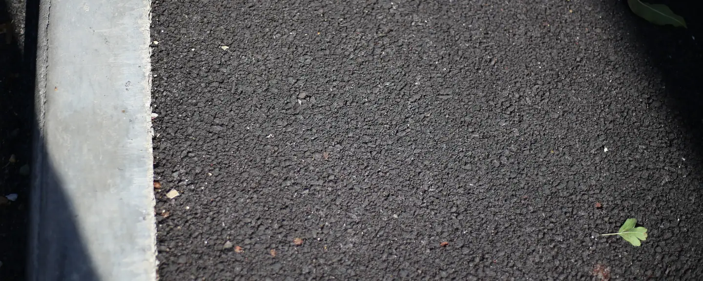 The edge of a newly surfaced path in shadow — Path Resurfacing in Brixton by Meads Resurfacing