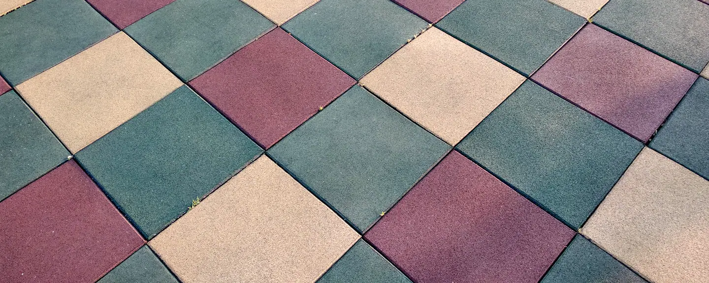 A play surface finished in coloured squares — Playground Resurfacing in Halstead by Meads Resurfacing