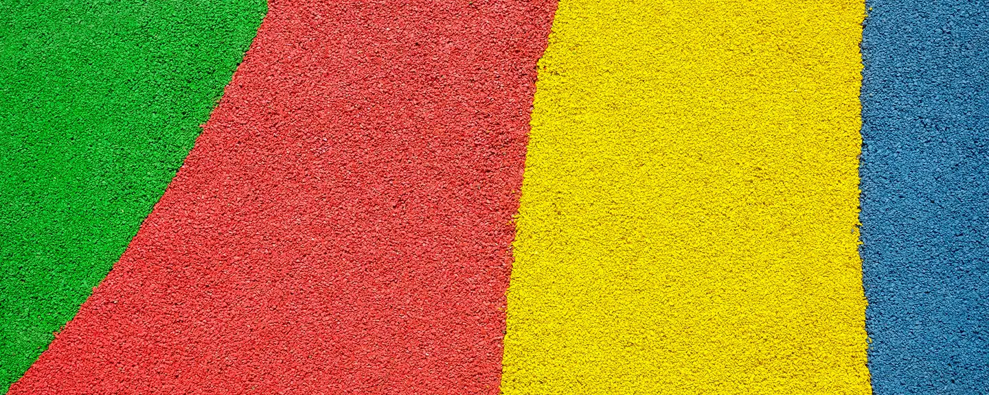 Coloured surfacing laid in banded stripes — Playground Resurfacing in Hammersmith by Meads Resurfacing
