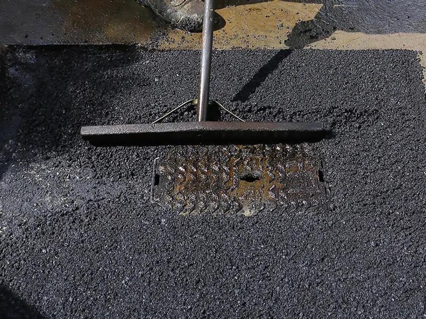 A pothole filled with standing water before repair