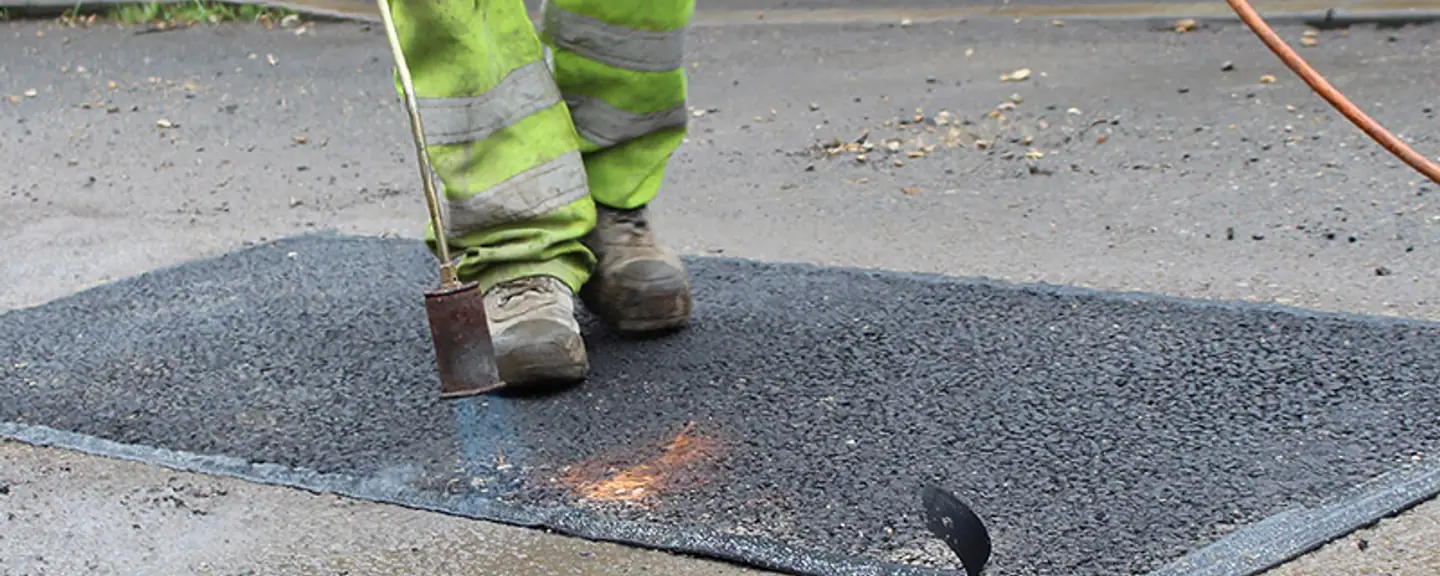 Broken tarmac being lifted out before filling — Pothole Repairs in Halstead by Meads Resurfacing