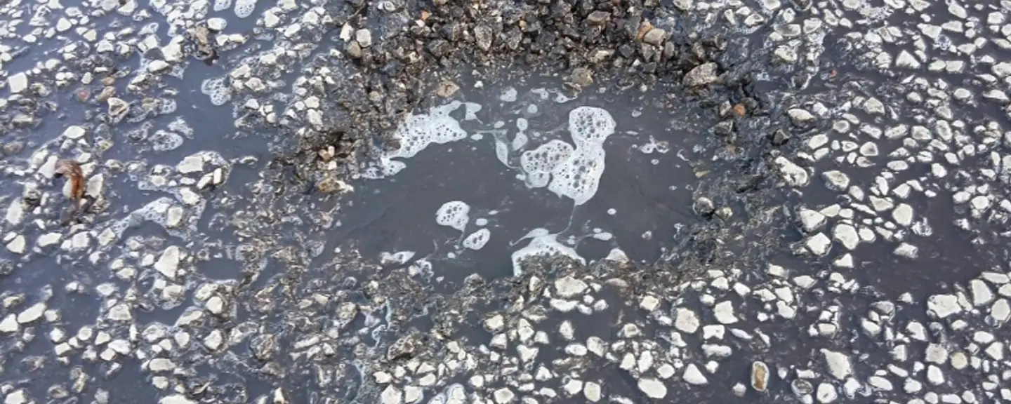 A deep pothole in a worn road surface — Pothole Repairs in Hackney by Meads Resurfacing