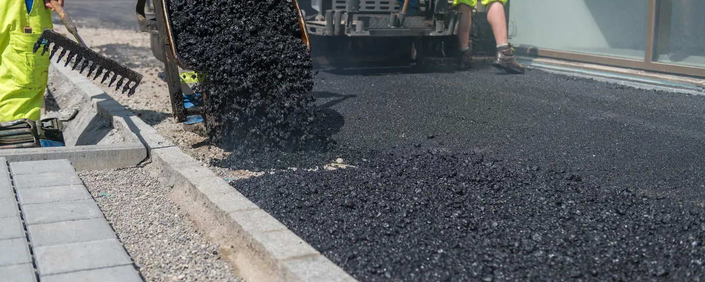 A new asphalt course laid up to the kerb line — Road Resurfacing in Ruislip by Meads Resurfacing