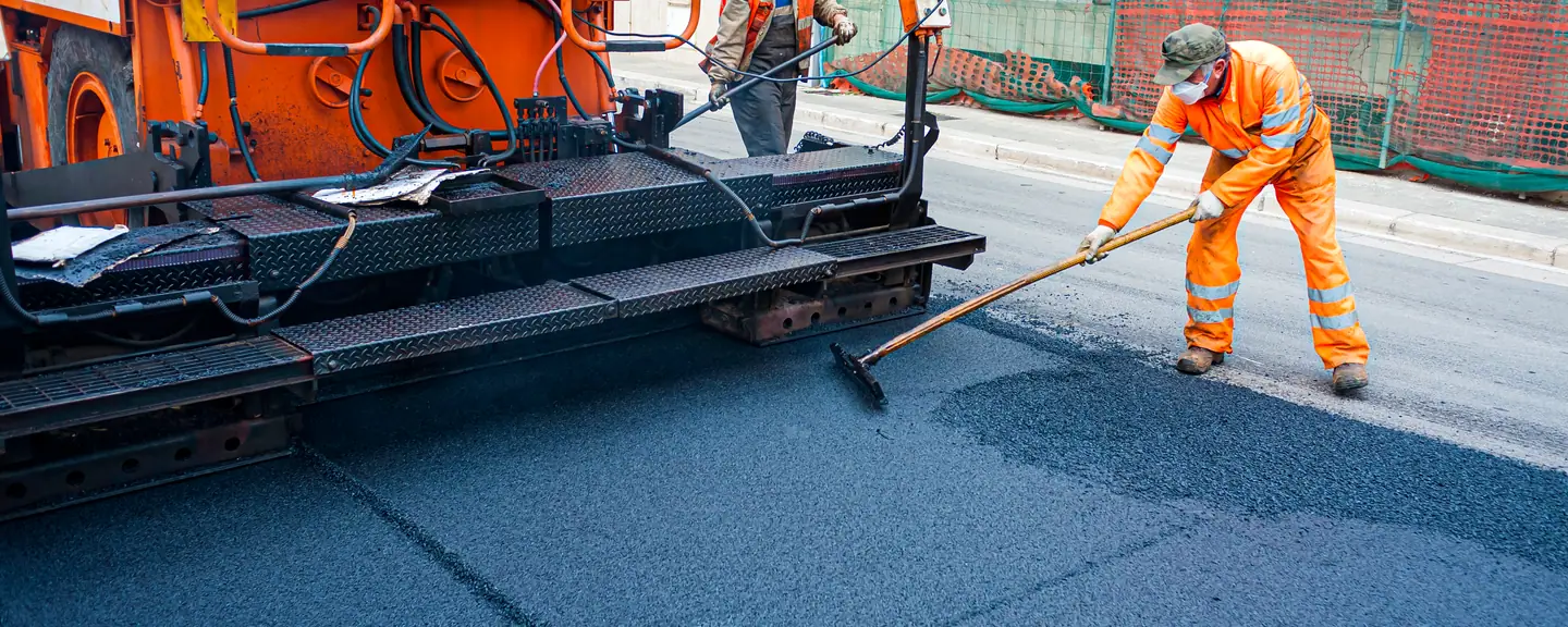 A paving machine feeding a new surface course — Road Resurfacing in Putney by Meads Resurfacing