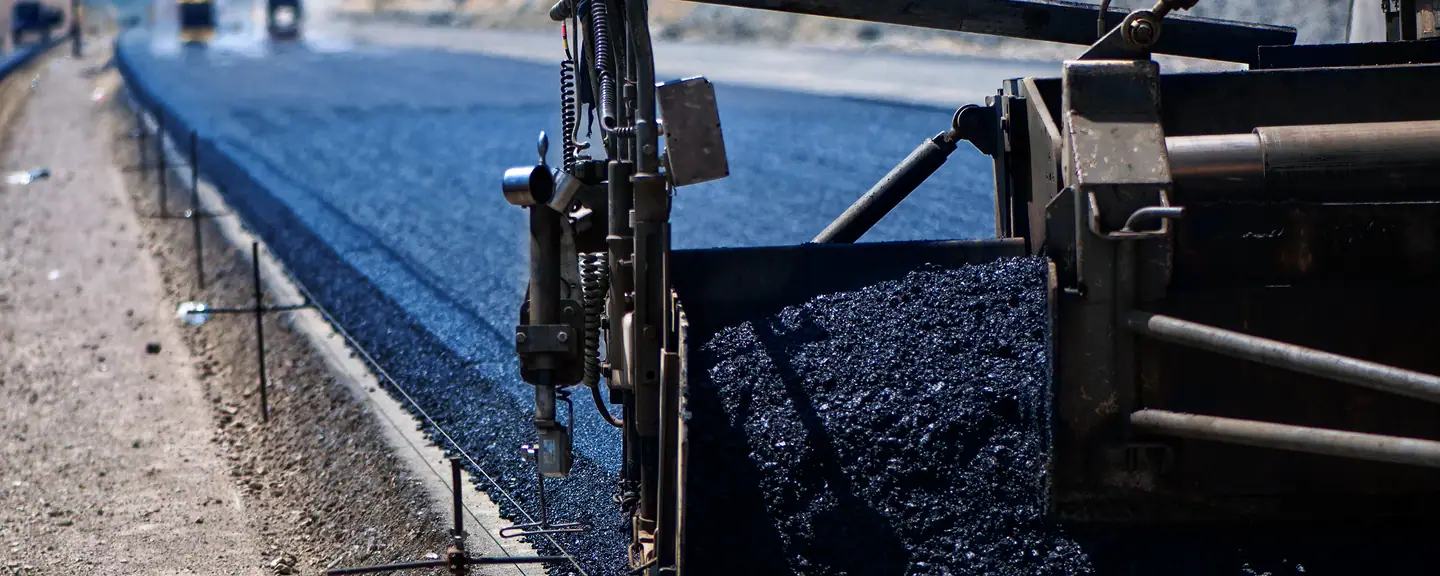 The screed of a paver laying an asphalt mat — Road Resurfacing in Whyteleaf by Meads Resurfacing