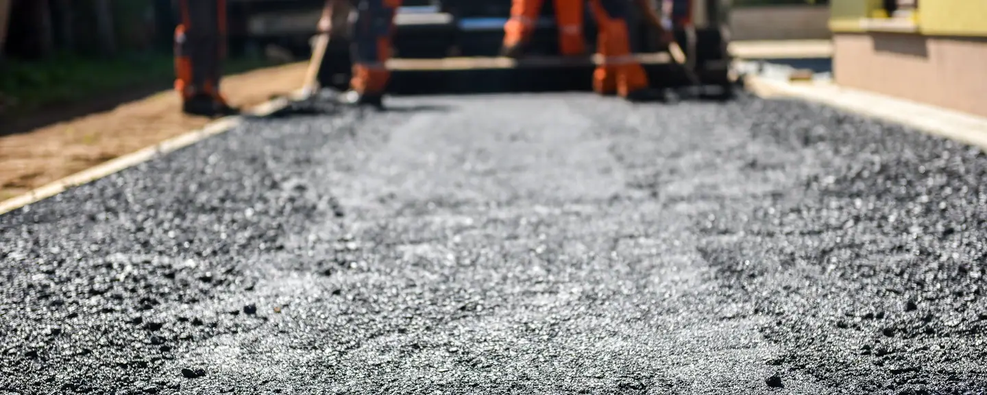 A fresh strip of asphalt beside the old surface — Road Resurfacing in Chiswick by Meads Resurfacing