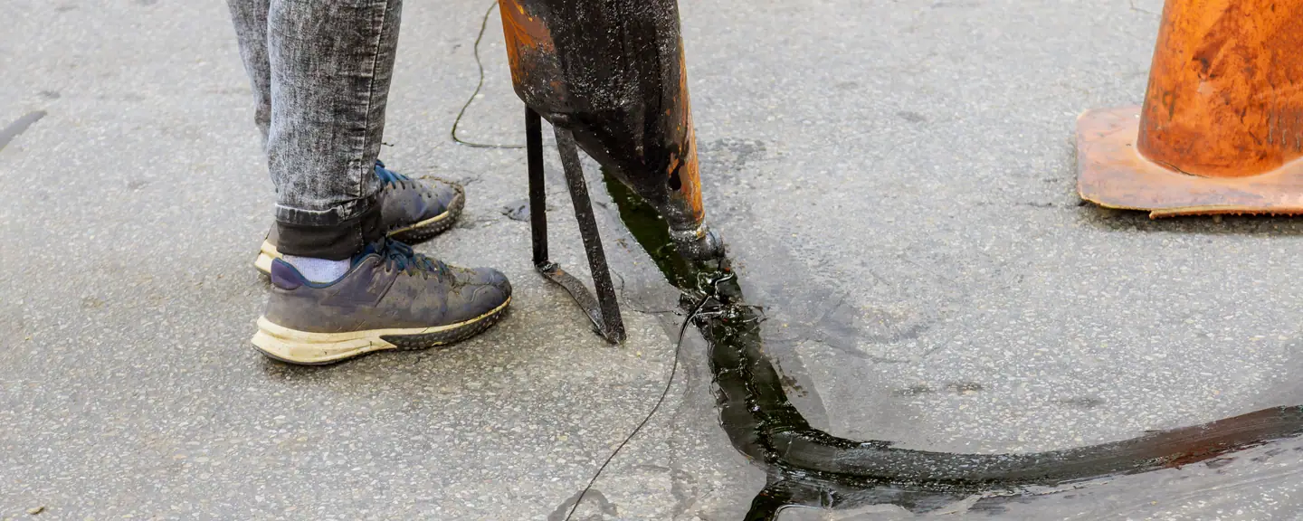 Sealant drawn across a jointed surface — Surface Dressing in Brixton by Meads Resurfacing
