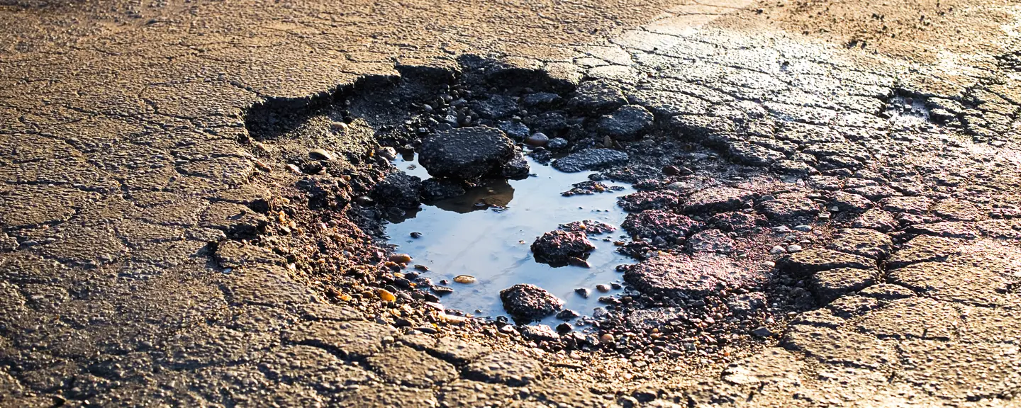 Broken asphalt at the edge of the carriageway — Tarmac Asphalt Repairs in Ramsgate by Meads Resurfacing