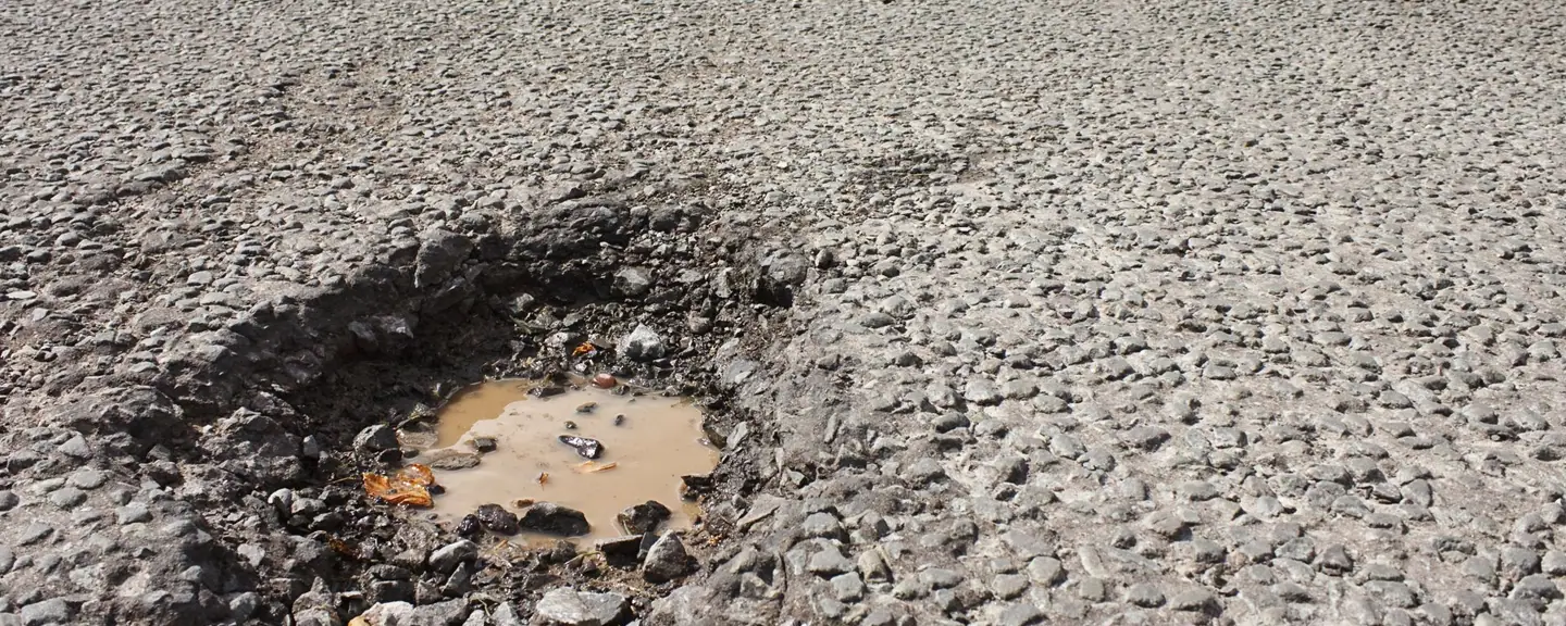 A repaired section of asphalt road — Tarmac Asphalt Repairs in Piccadilly by Meads Resurfacing