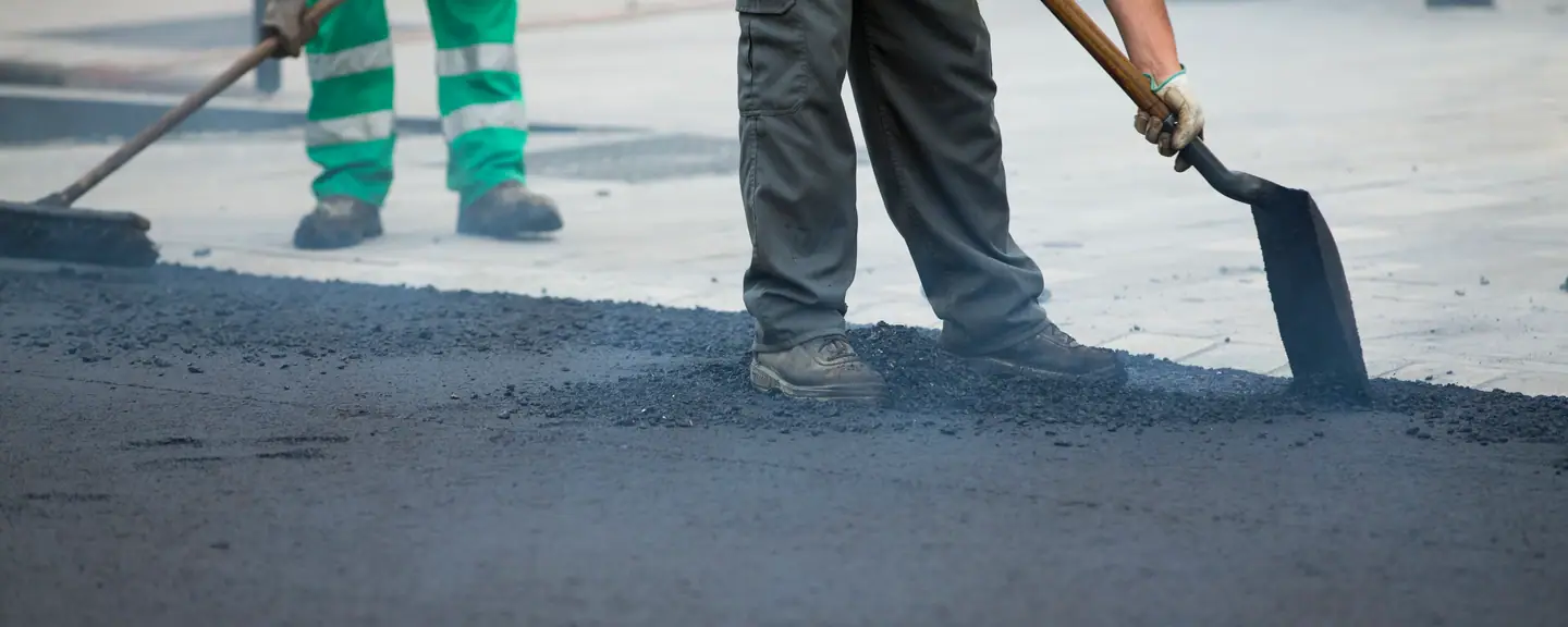 Two contractors shovelling tarmac — Tarmac Contractors in Dover by Meads Resurfacing