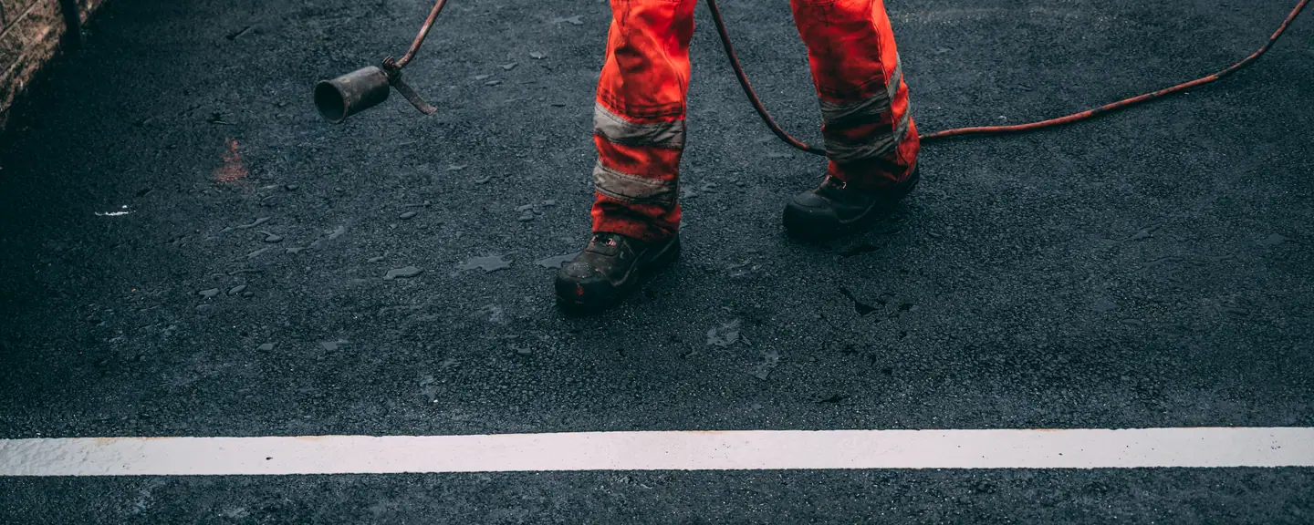 A contractor working alongside a painted line — Tarmac Contractors in Folkestone by Meads Resurfacing