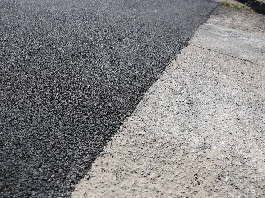 A finished tarmac surface with a clean kerb edge