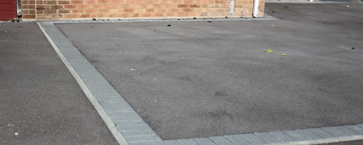 A tarmac driveway with a contrasting block band — Tarmac Driveways in Halstead by Meads Resurfacing